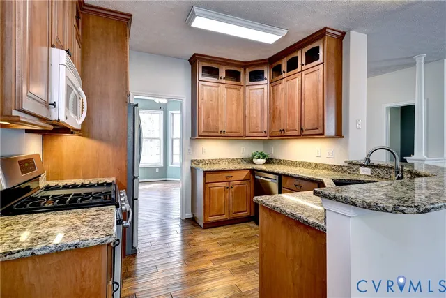 a kitchen with a refrigerator stove and sink