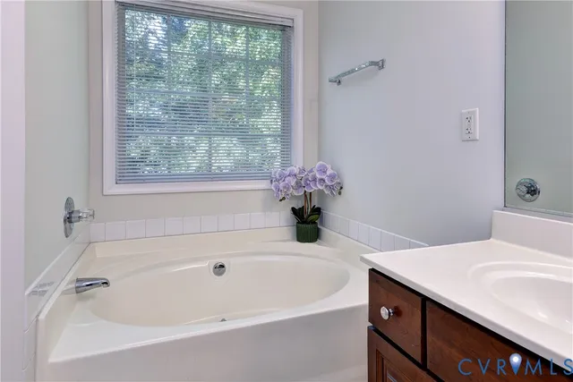 a white bath tub sitting next to a white sink