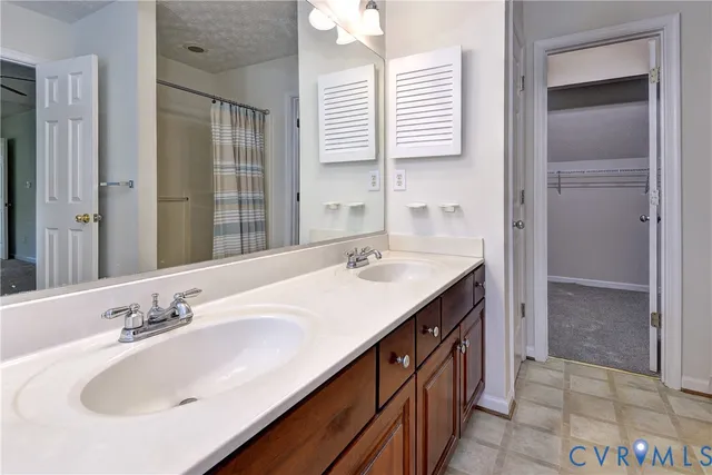 a bathroom with a sink double vanity and a mirror