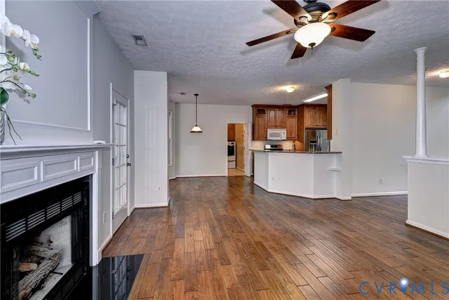 a view of a kitchen with a sink a refrigerator and a fireplace