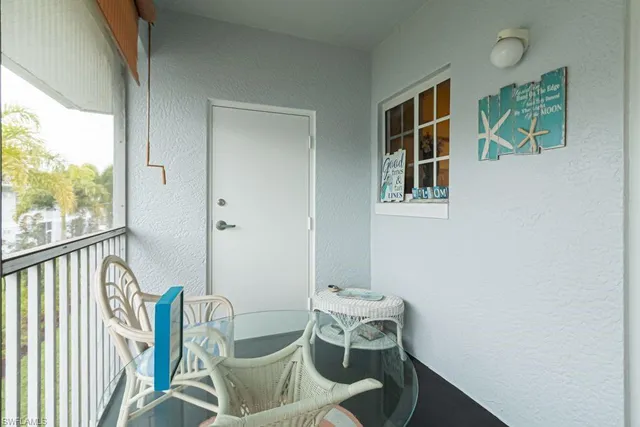 a view of a window and chair in the balcony