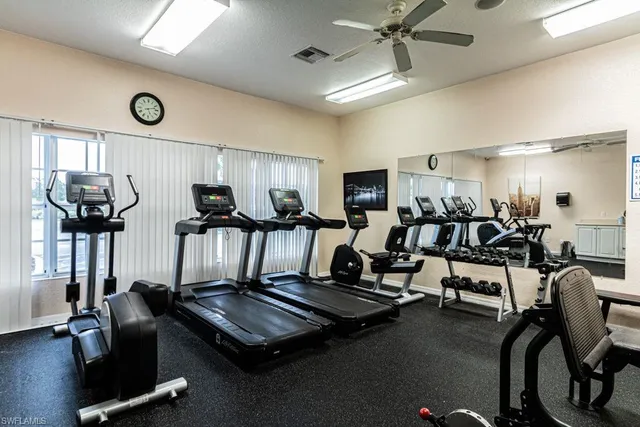 a room with gym equipment and a large window