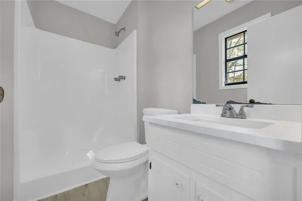 a bathroom with a sink toilet and shower
