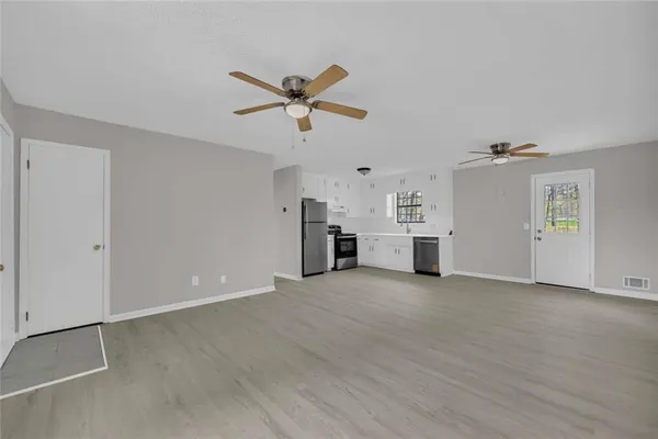 a view of a kitchen with furniture and a ceiling fan
