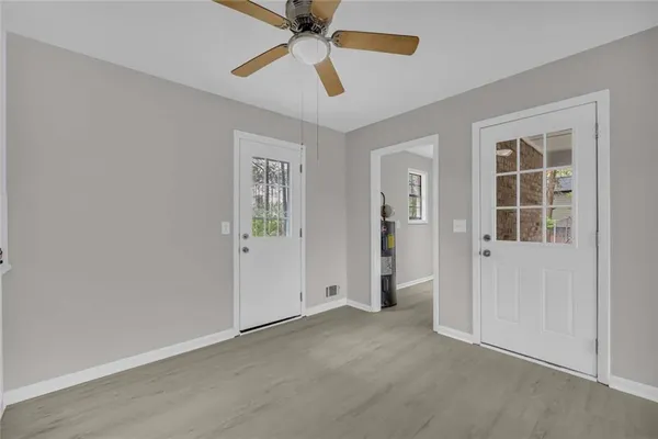 an empty room with closet and windows