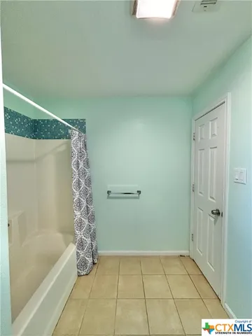 a bathroom with a bathtub and shower