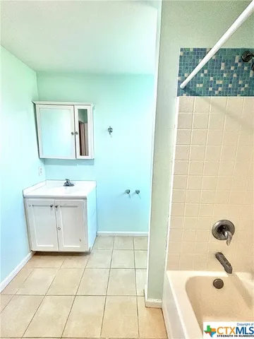 a bathroom with a sink a vanity and mirror