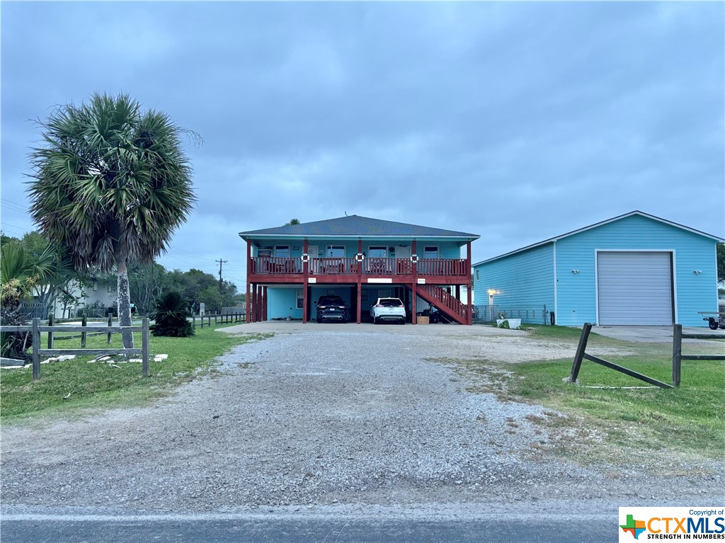 512 West Adams Street Port O'Connor, TX 77982 - Photo 2 of 27 a front view of a house with garden