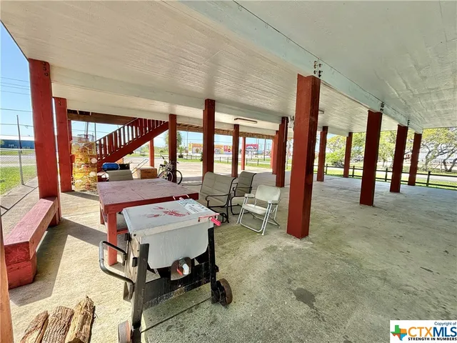 a living room with furniture a large window and a rug