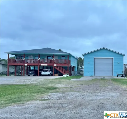 a view of a house with a yard and garage