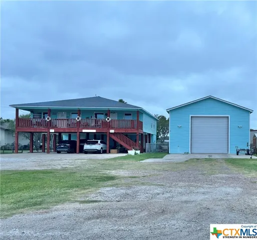 a view of a house with a yard and garage