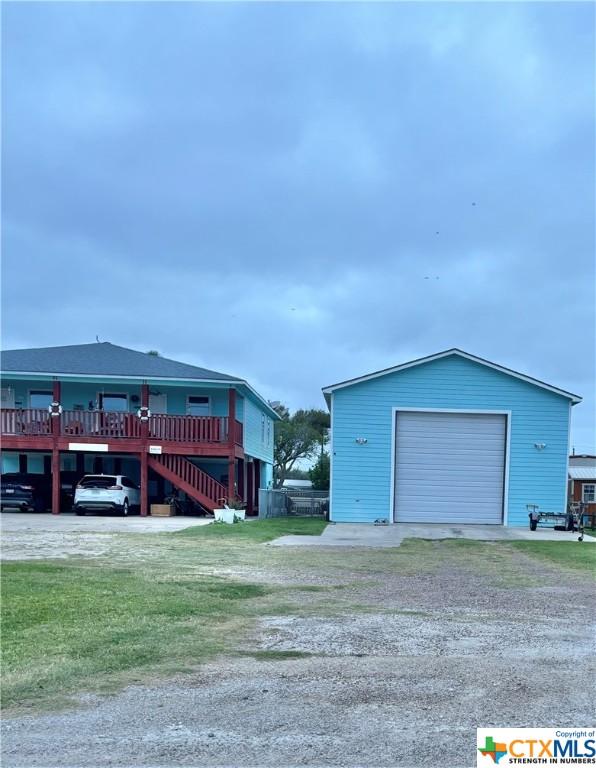 512 West Adams Street Port O'Connor, TX 77982 - Photo 4 of 27 a front view of a house with a yard and garage