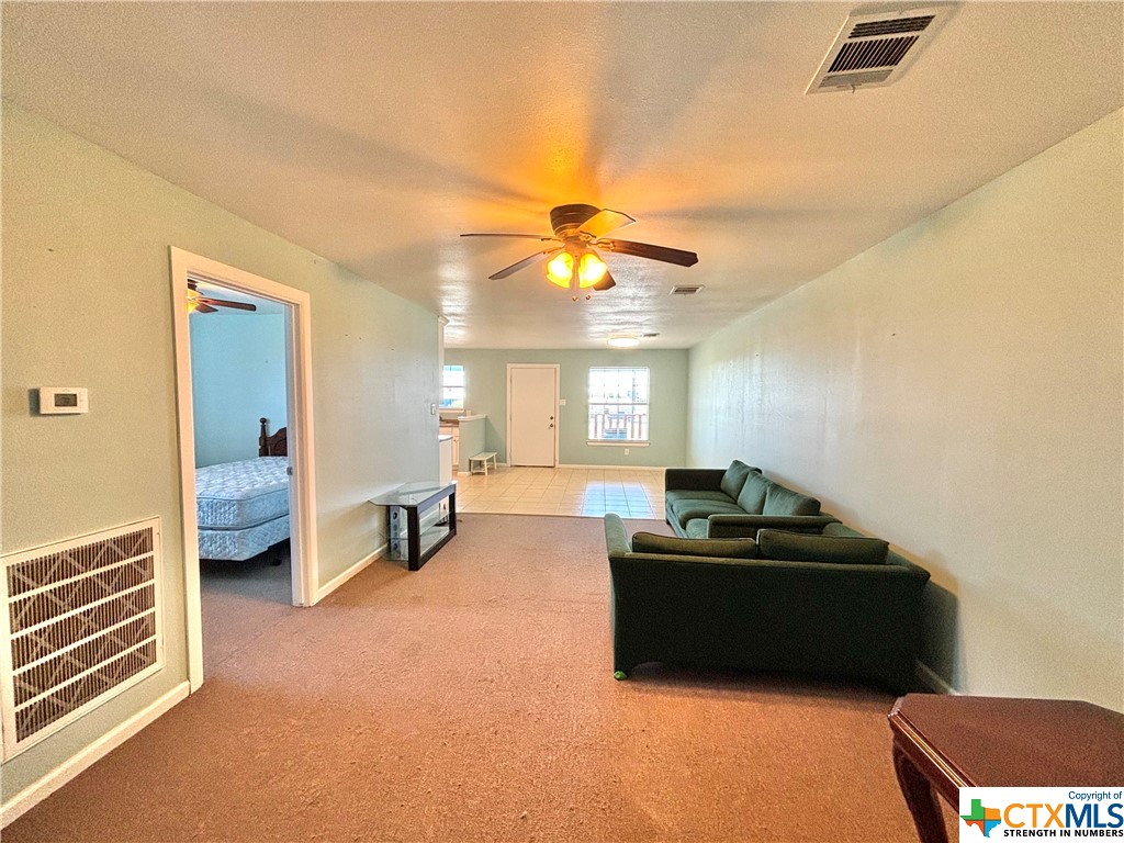 512 West Adams Street Port O'Connor, TX 77982 - Photo 10 of 27 a living room with furniture and a chandelier