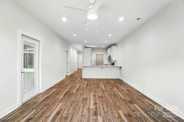 a bedroom with a large bed and a potted plant