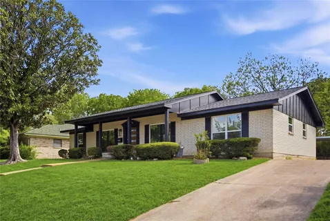 a front view of a house with a garden