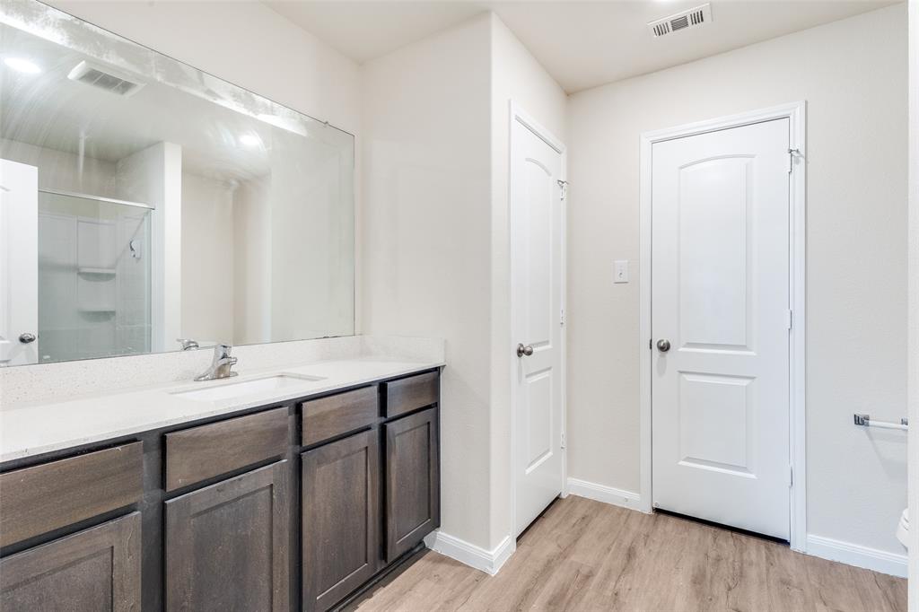 144 Barbwire Way Newark, TX 76071 - Photo 12 of 24 a bathroom with a sink and a mirror