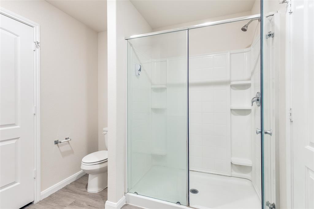 144 Barbwire Way Newark, TX 76071 - Photo 13 of 24 a bathroom with a shower and a toilet