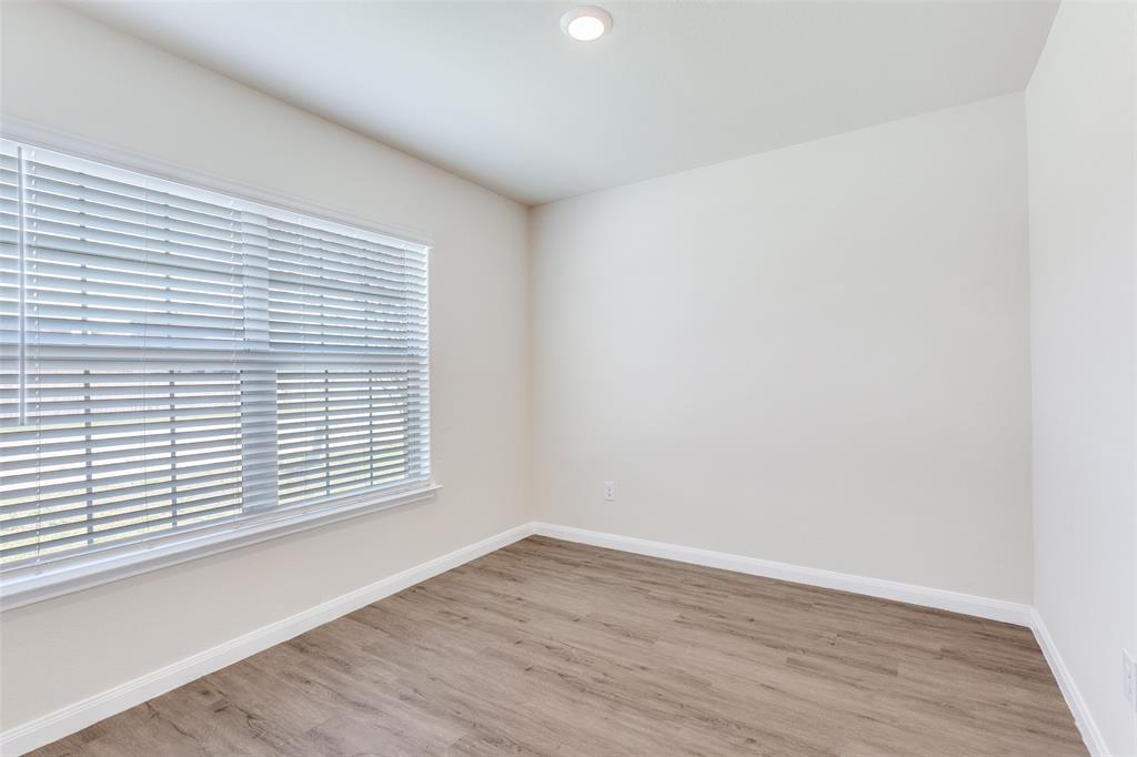 144 Barbwire Way Newark, TX 76071 - Photo 15 of 24 wooden floor in an empty room with a window