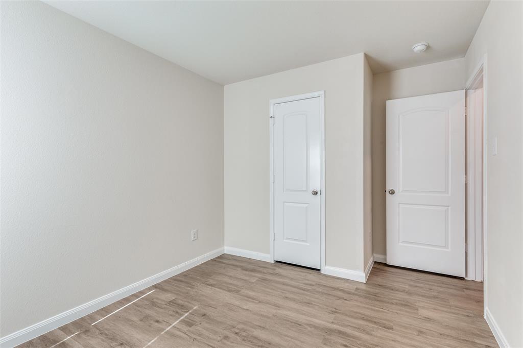 144 Barbwire Way Newark, TX 76071 - Photo 18 of 24 a view of an empty room and wooden floor