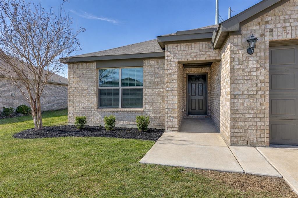 144 Barbwire Way Newark, TX 76071 - Photo 2 of 24 a front view of a house with a yard