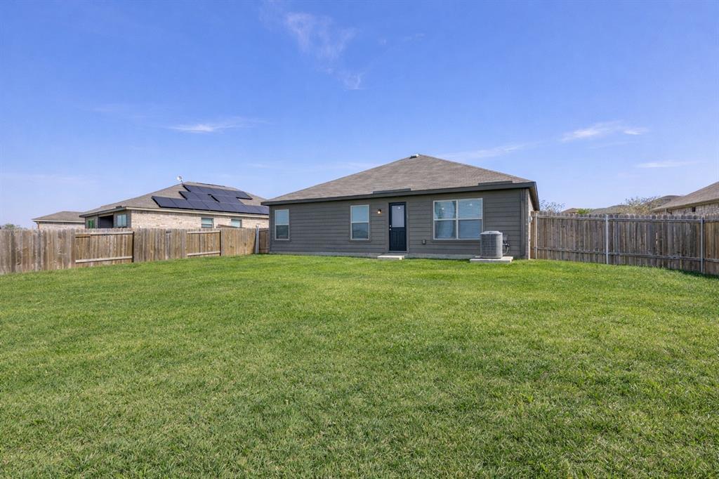 144 Barbwire Way Newark, TX 76071 - Photo 22 of 24 a front view of a house with garden