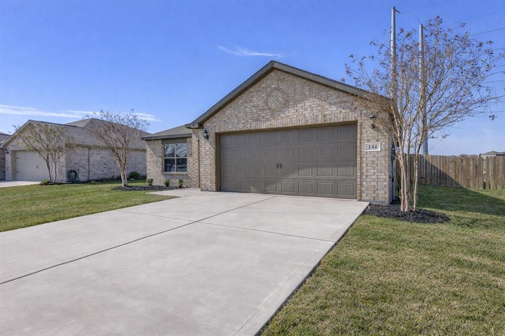 144 Barbwire Way Newark, TX 76071 - Photo 24 of 24 a front view of a house with a yard and garage
