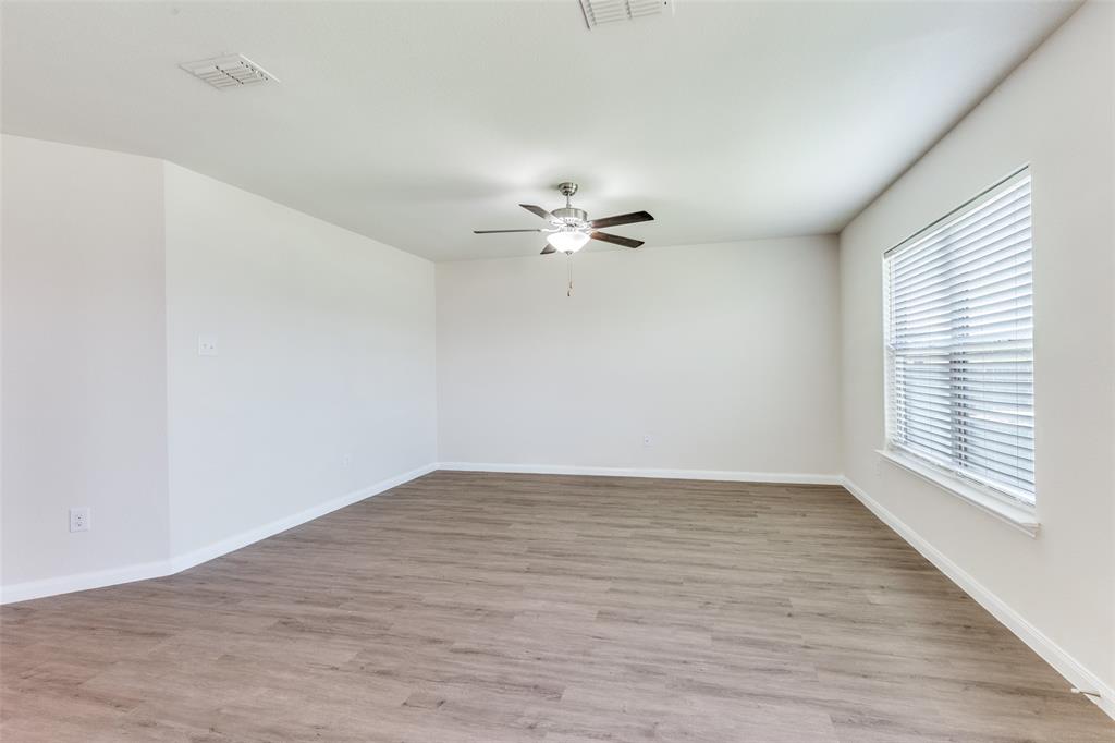 144 Barbwire Way Newark, TX 76071 - Photo 7 of 24 wooden floor in an empty room with a window