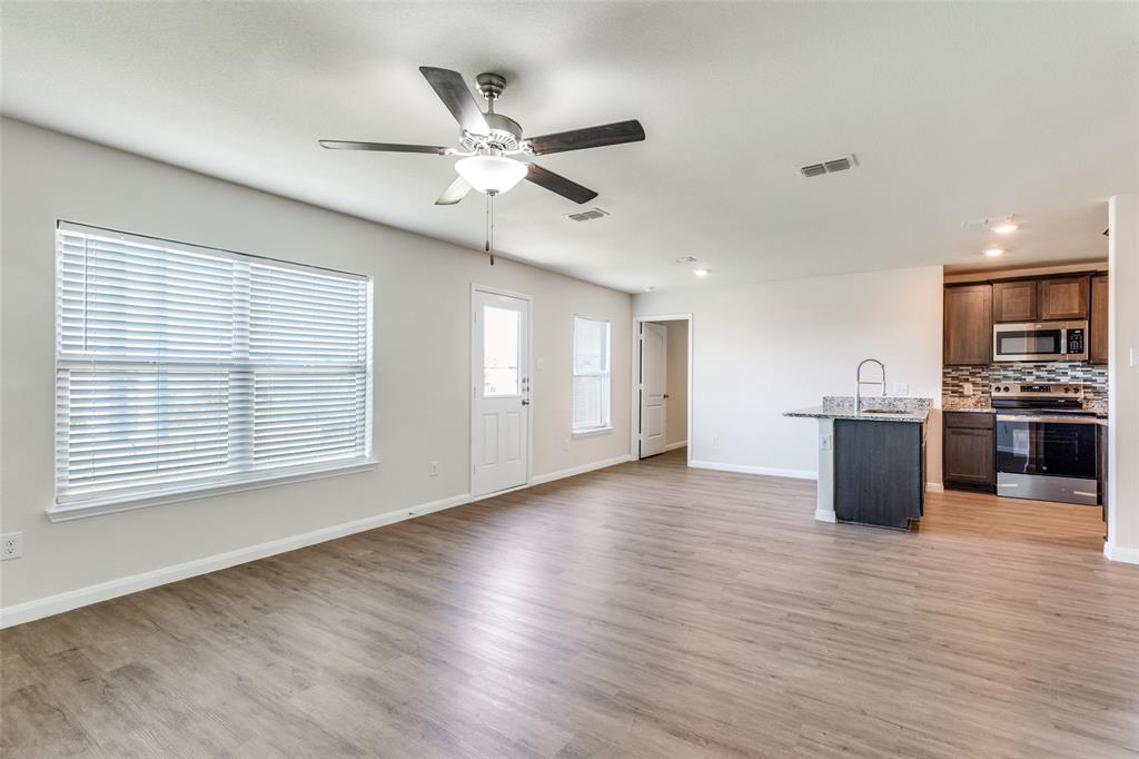 144 Barbwire Way Newark, TX 76071 - Photo 8 of 24 a view of an empty room with kitchen appliances and a window