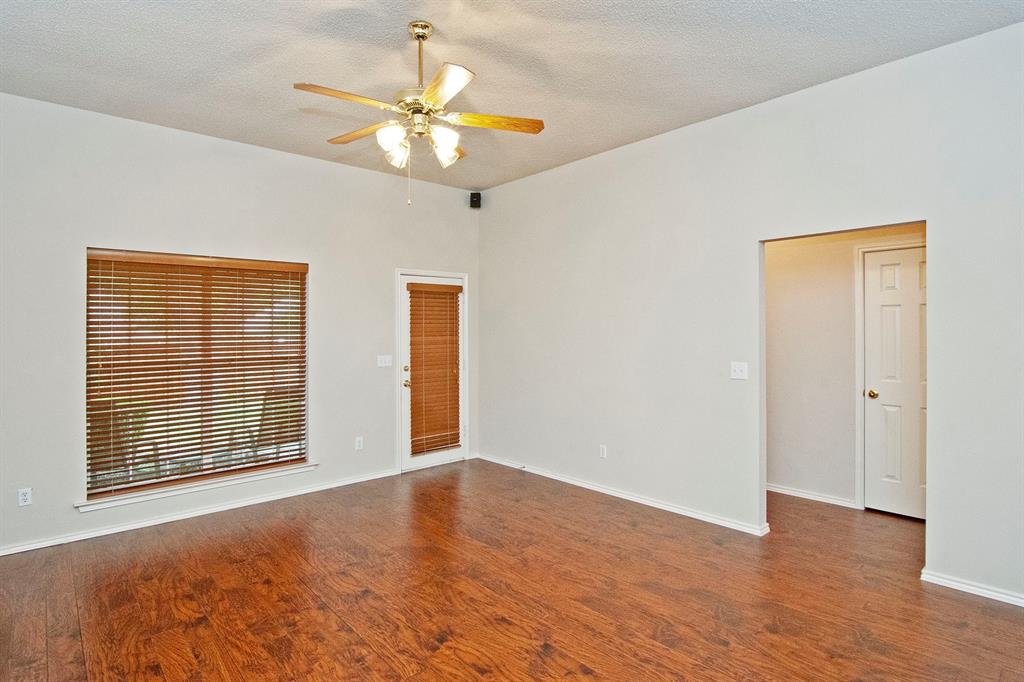 7757 Lancelot Road Frisco, TX 75035 - Photo 14 of 27 Unfurnished room with a textured ceiling, wood finished floors, and a ceiling fan