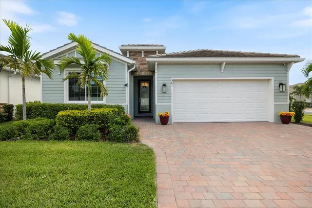 a front view of house with garage and yard