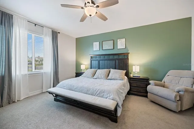 a bedroom with a bed couch and window