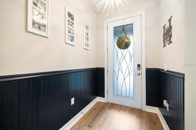 a view of a hallway to rooms and wooden floor
