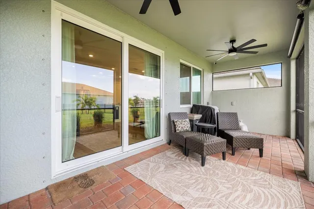 a living room with furniture and a floor to ceiling window