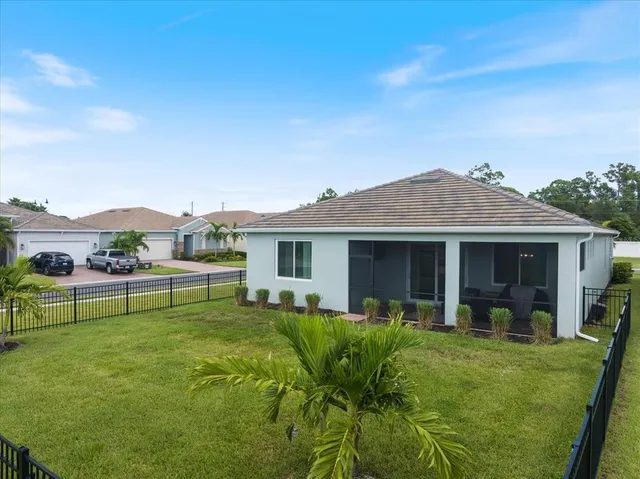 a view of a house with patio and a garden