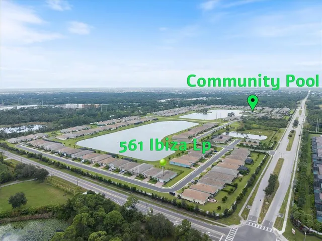 a view of a swimming pool with a yard and plants
