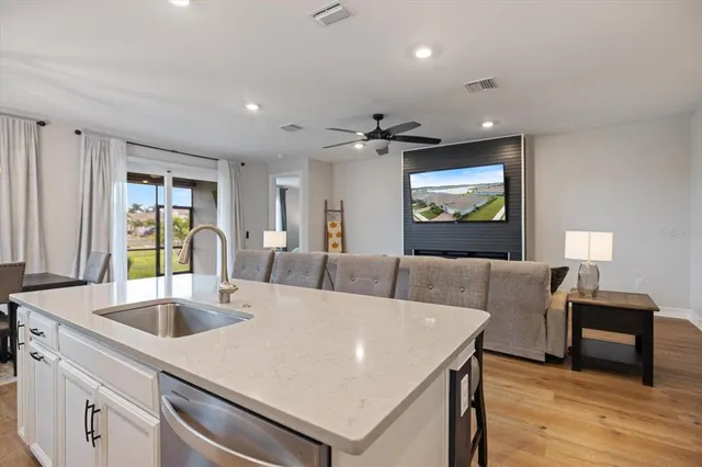 a large white kitchen with a large window