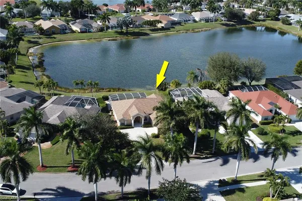 an aerial view of residential houses with outdoor space and lake view