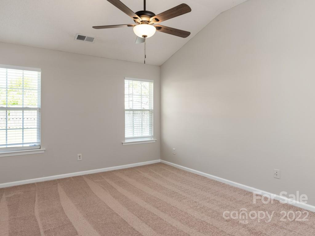 8215 Fox Swamp Road Charlotte, NC 28215 - Photo 11 of 25 an empty room with windows and fan