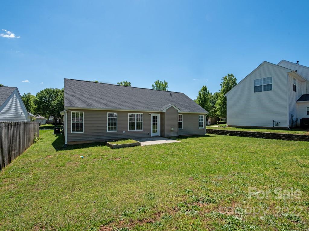 8215 Fox Swamp Road Charlotte, NC 28215 - Photo 20 of 25 a house that is sitting in the grass with wooden fence