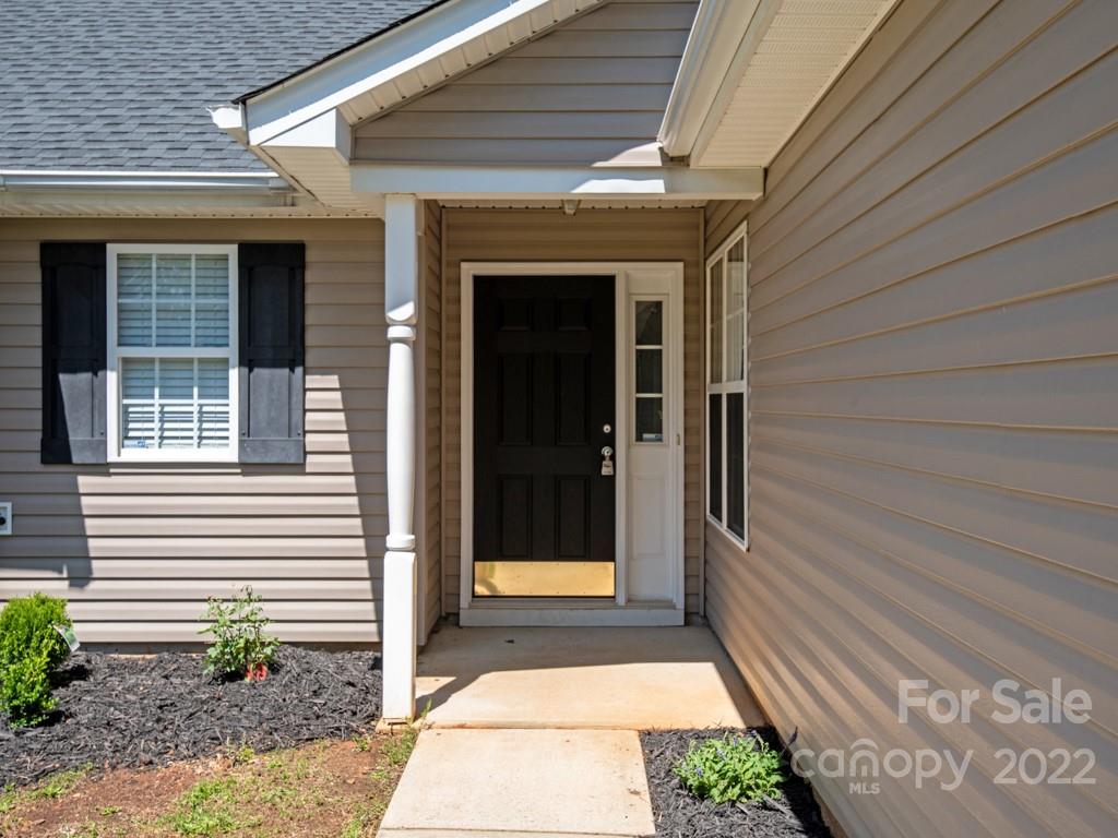 8215 Fox Swamp Road Charlotte, NC 28215 - Photo 2 of 25 a front view of a house with a blue gate
