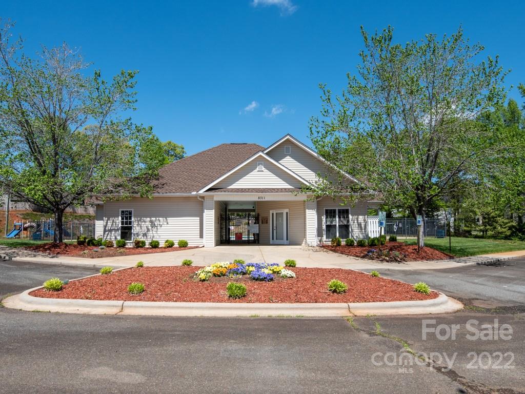 8215 Fox Swamp Road Charlotte, NC 28215 - Photo 23 of 25 a front view of a building with many windows