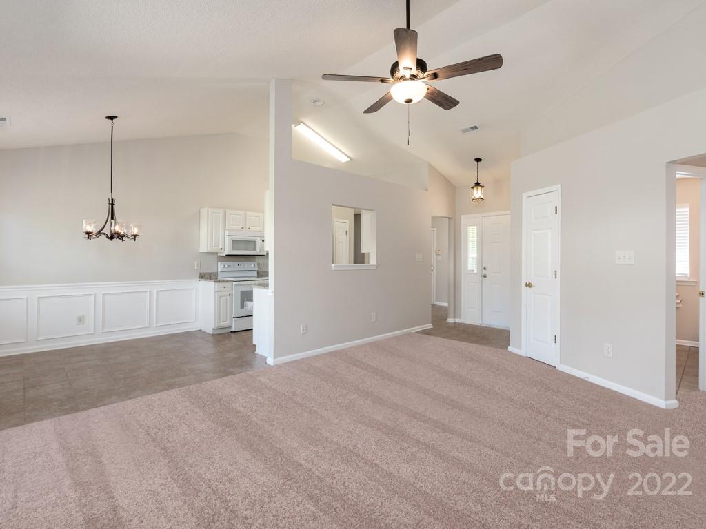 8215 Fox Swamp Road Charlotte, NC 28215 - Photo 3 of 25 a view of an empty room with a ceiling fan