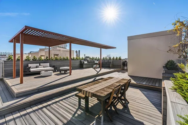 a view of a patio with table and chairs and potted plants