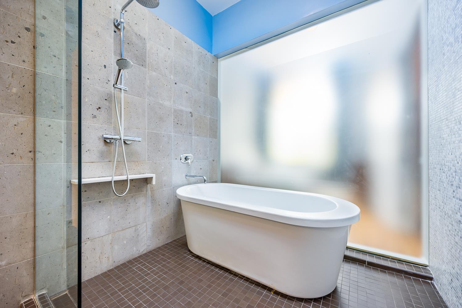 27-28 Thomson Avenue, Unit 804 Queens, NY 11101 - Photo 10 of 17 a white toilet sitting next to a bathroom sink and shower