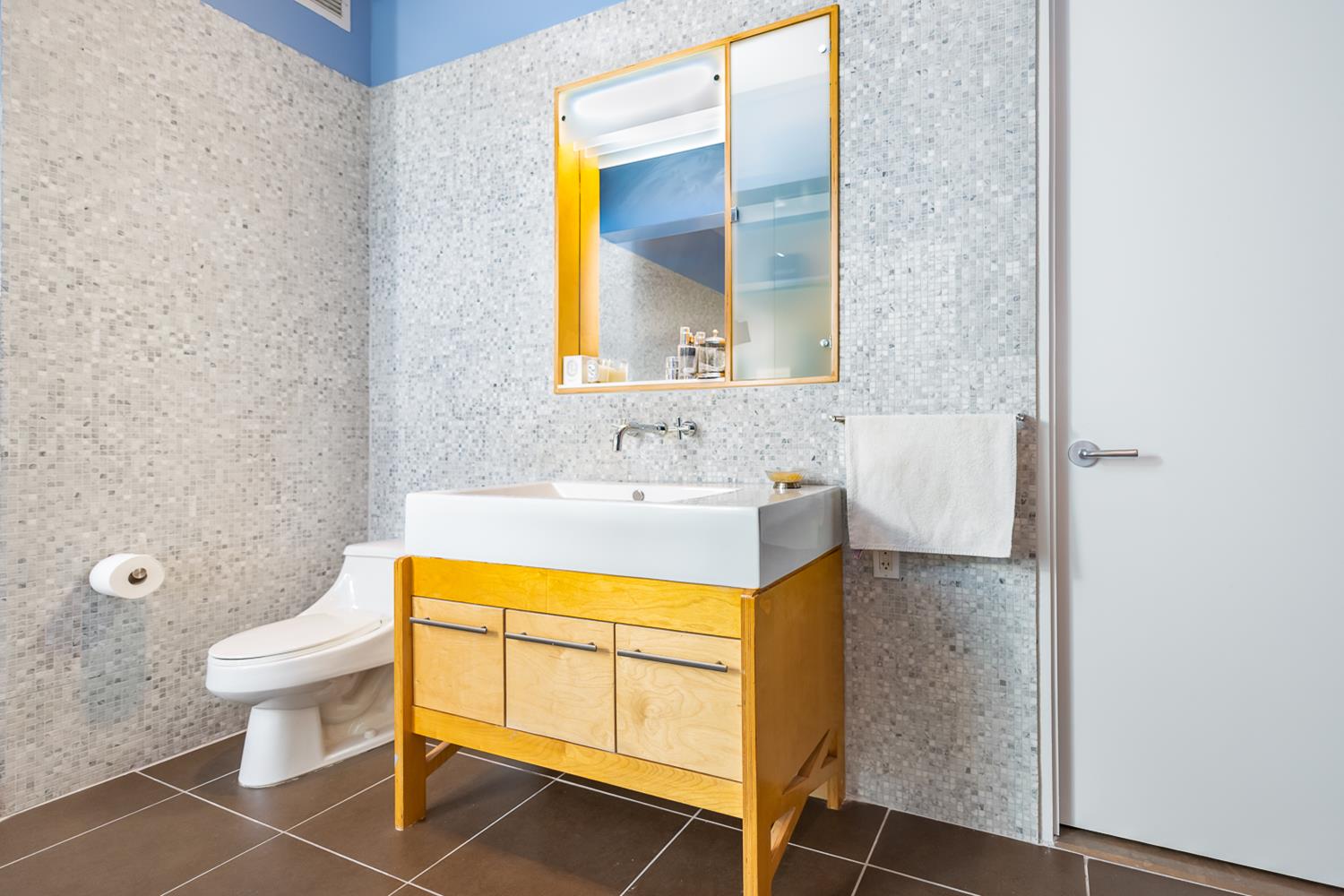 27-28 Thomson Avenue, Unit 804 Queens, NY 11101 - Photo 11 of 17 a bathroom with a sink toilet and mirror