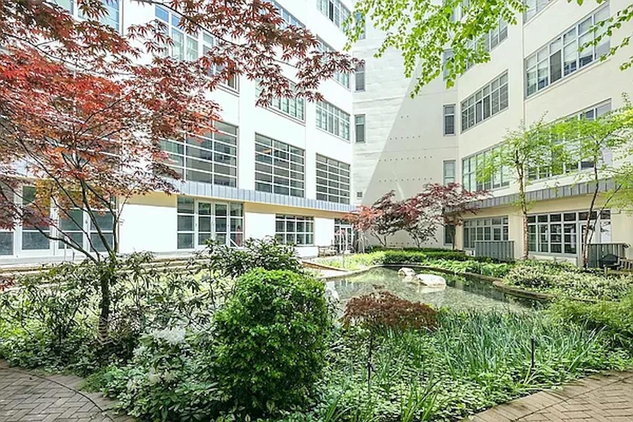 27-28 Thomson Avenue, Unit 804 Queens, NY 11101 - Photo 15 of 17 front view of a building with a garden