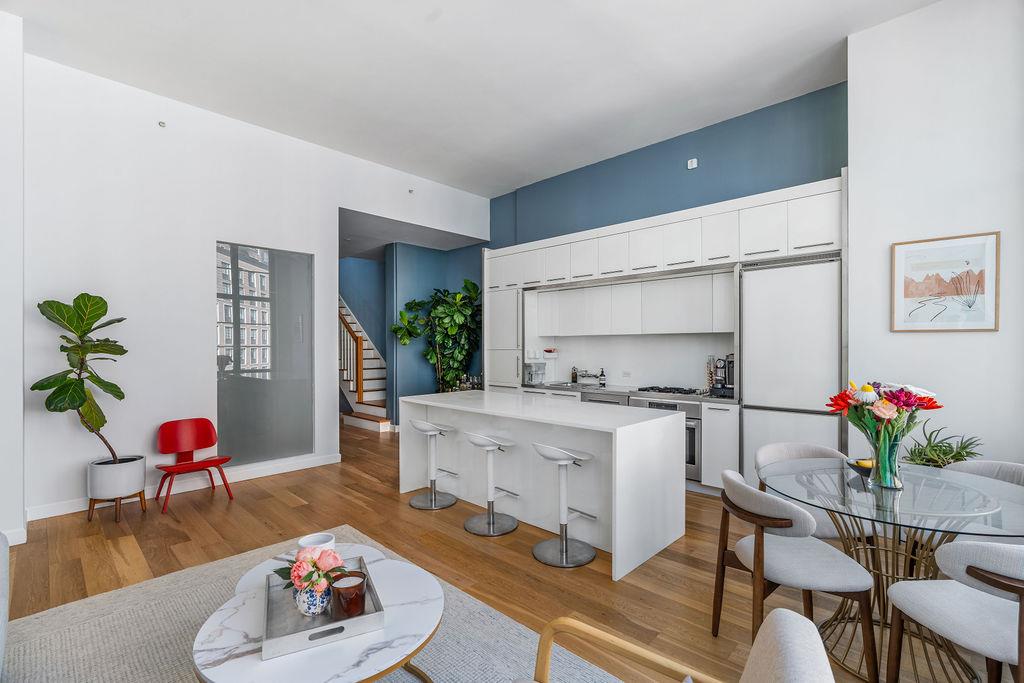 27-28 Thomson Avenue, Unit 804 Queens, NY 11101 - Photo 3 of 17 a living room with furniture and a potted plant