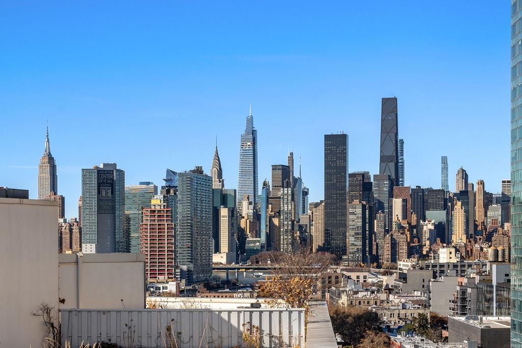 27-28 Thomson Avenue, Unit 804 Queens, NY 11101 - Photo 6 of 17 a view of a city with tall buildings