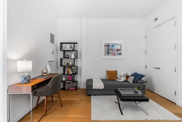 a living room with furniture and flowers