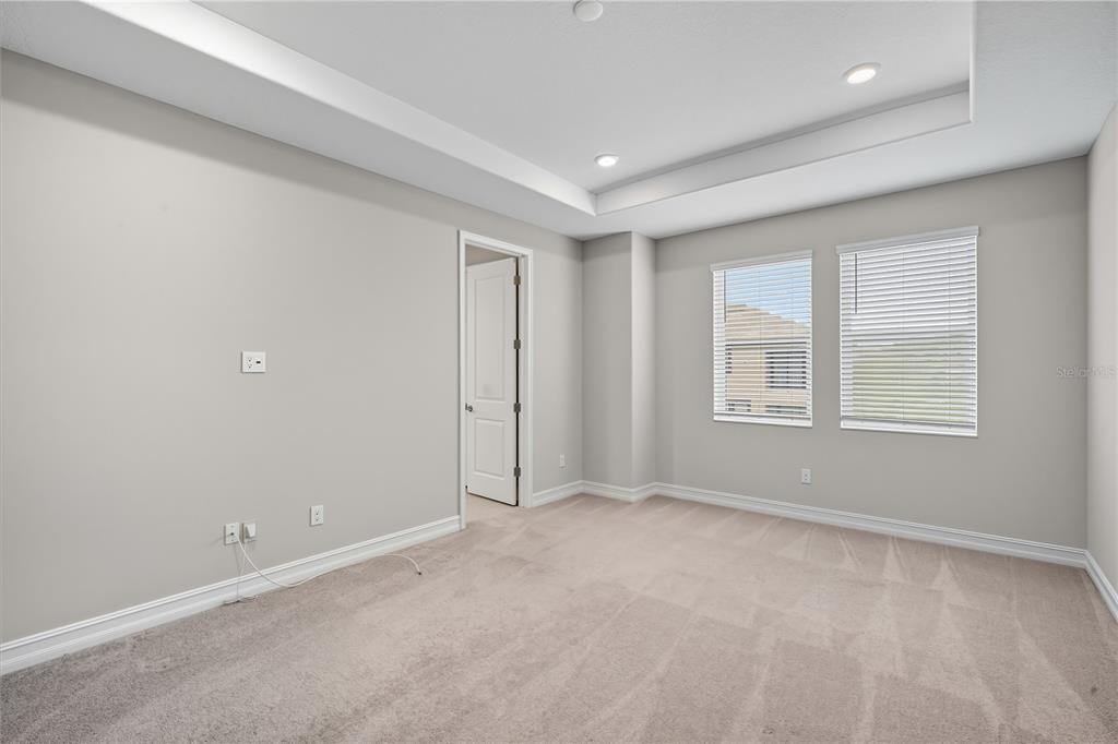 4663 Almada Lane Wesley Chapel, FL 33543 - Photo 12 of 30 an empty room with windows